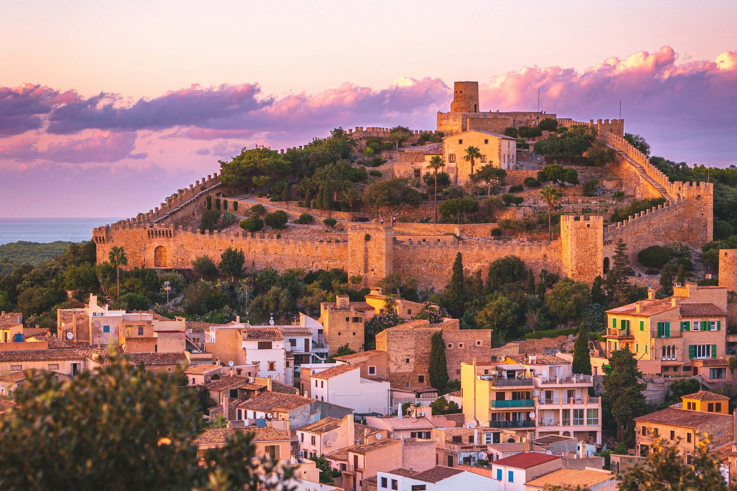 The medieval castle of Capdepera above the village at sunset