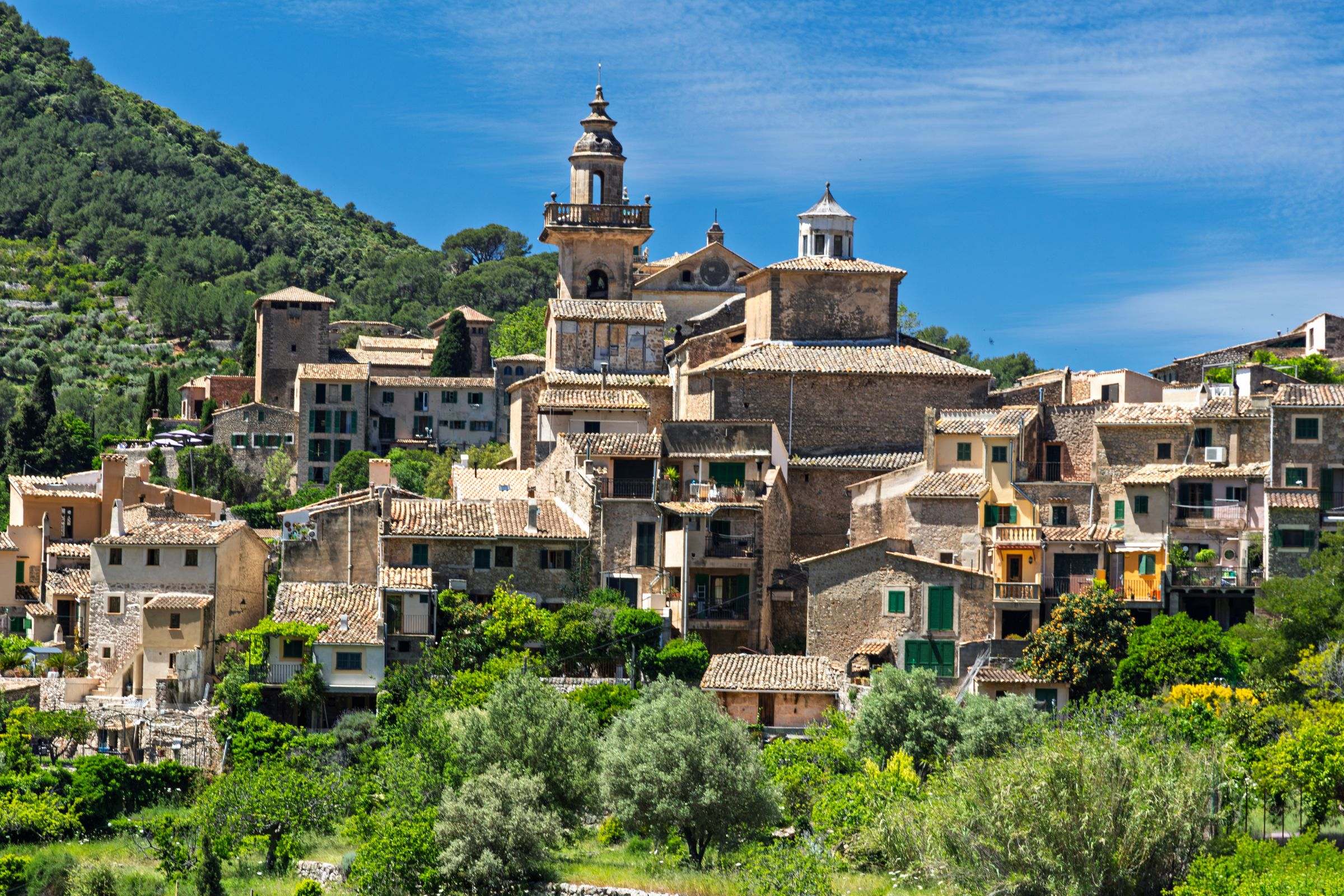 The stone village of Valldemossa and its Carthusian monastery tower in the Tramuntana hills